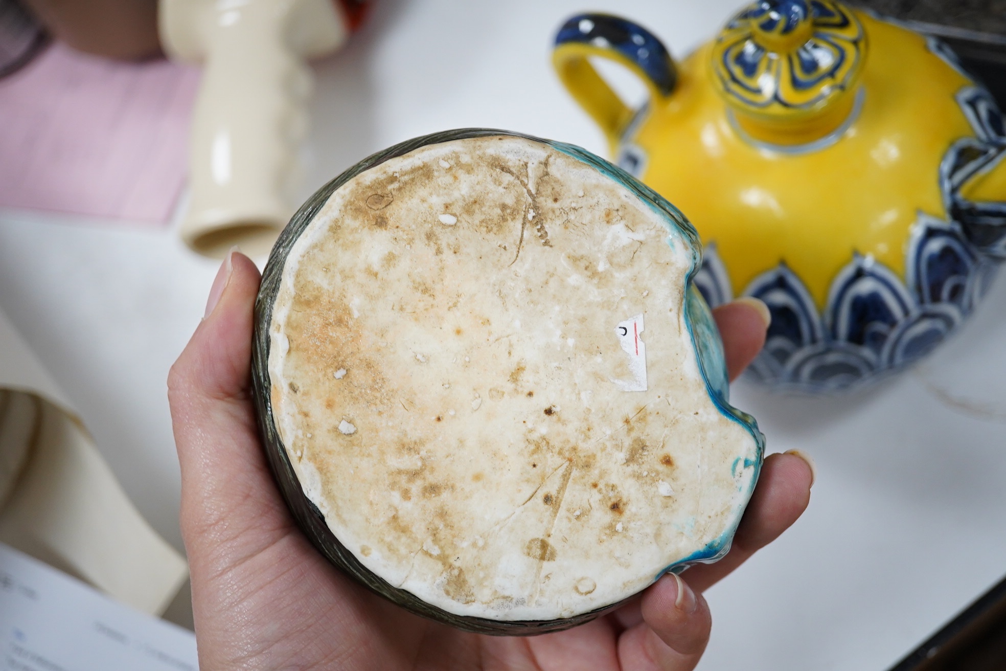 A Chinese yellow ground teapot, Xuande mark but later and a turquoise glazed ‘lion dog’ brush washer, tallest 13cm. Condition - good